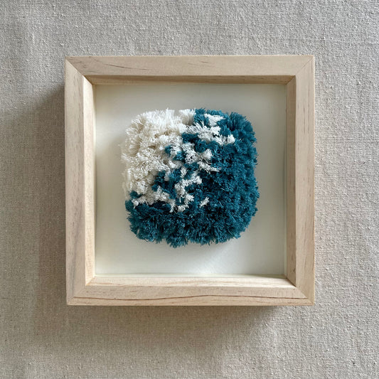 Ocean teal and cream fluffy textured woven wall art in a square wood deep box frame