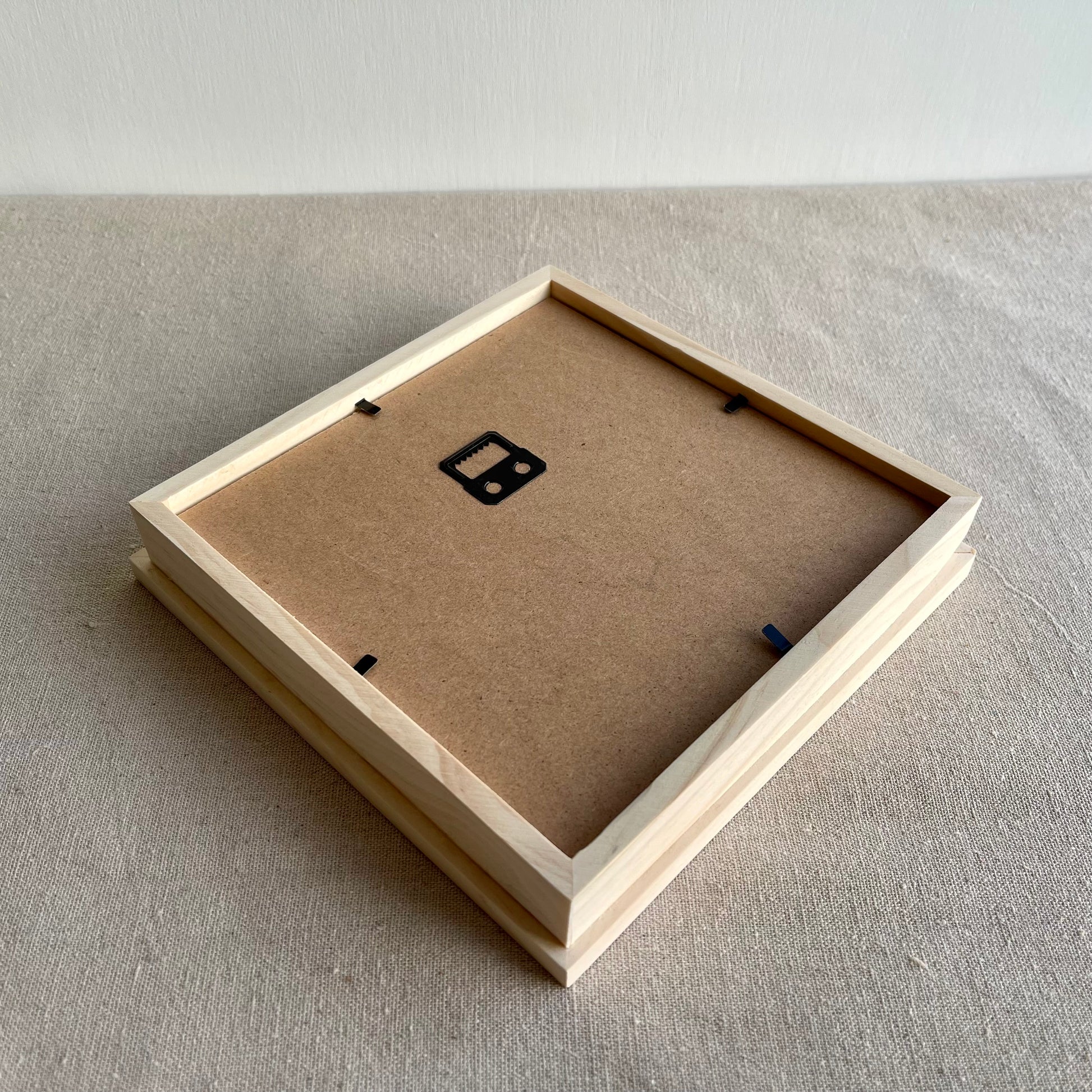 Back view of wooden frame with hanging hook