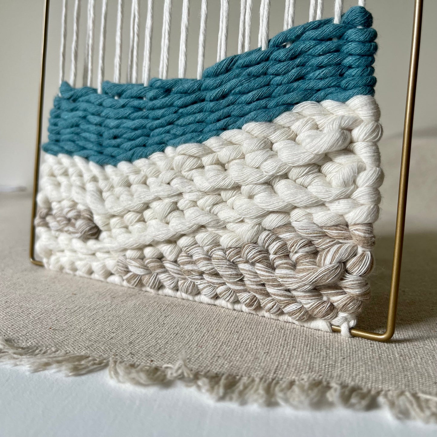 Close up detail of turquoise and cream coastal design weaving