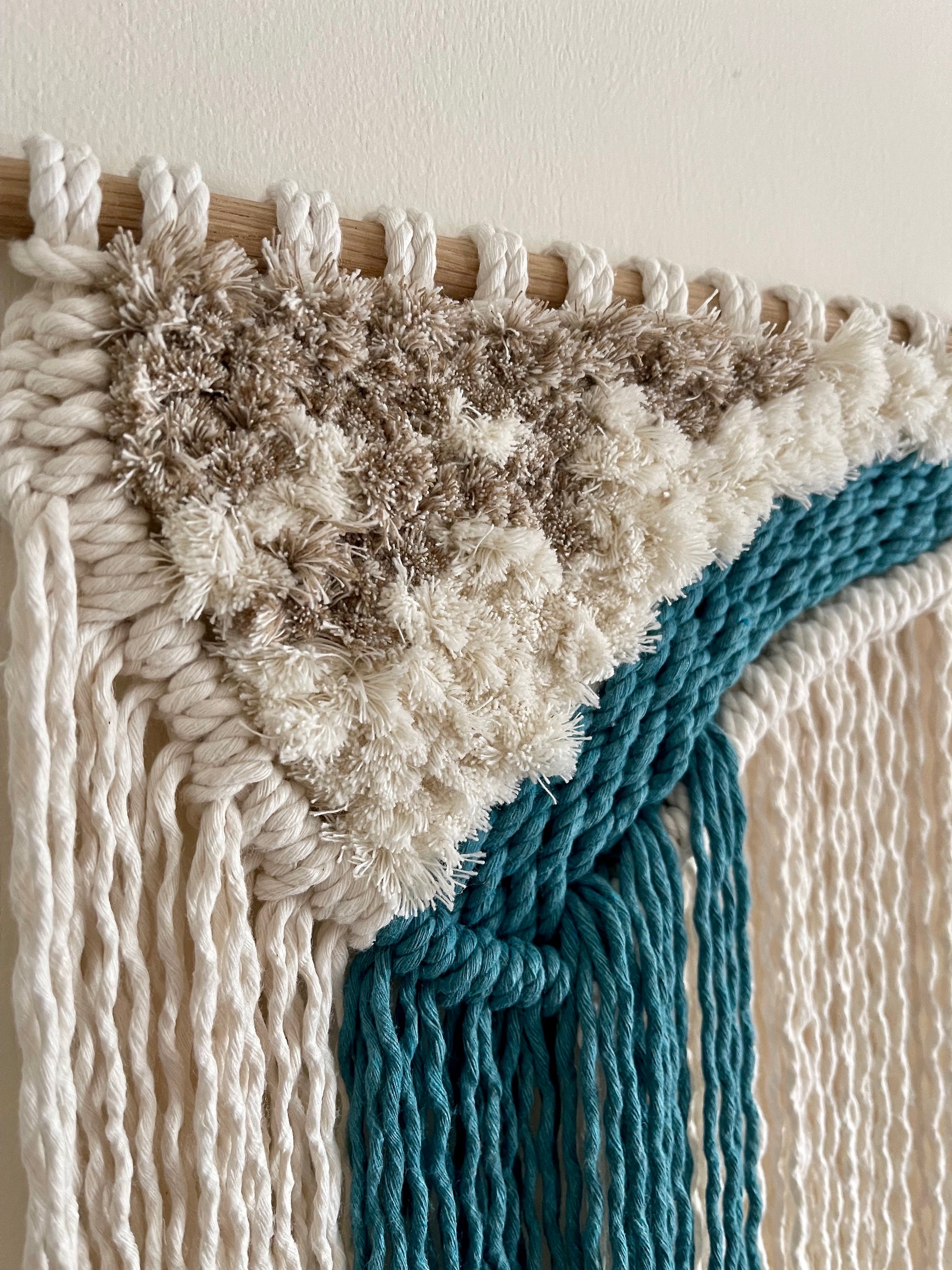 Handmade ocean inspired macraweave fibre wall hanging in cream and teal