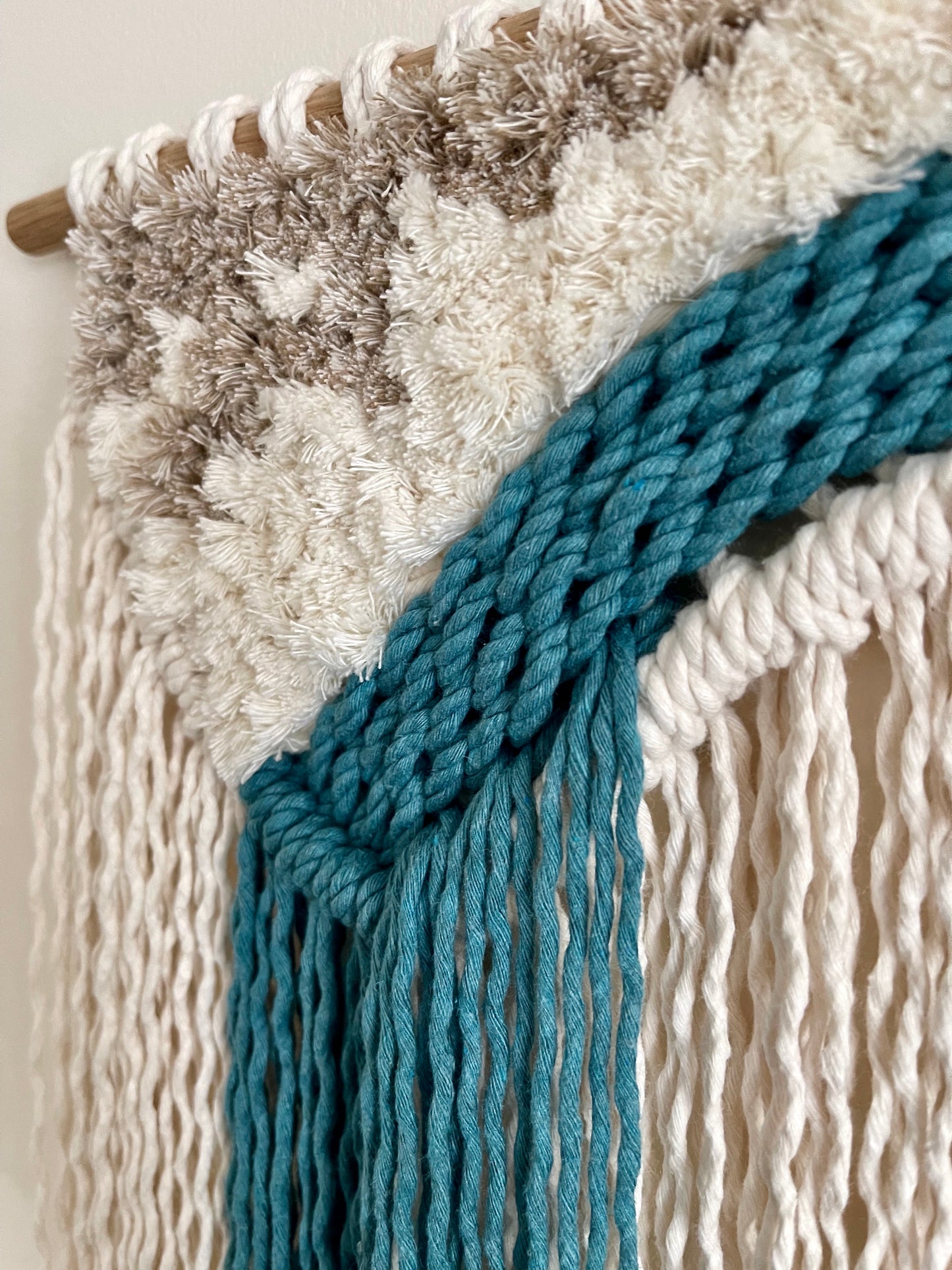 Handmade ocean inspired macraweave fibre wall hanging in cream and teal